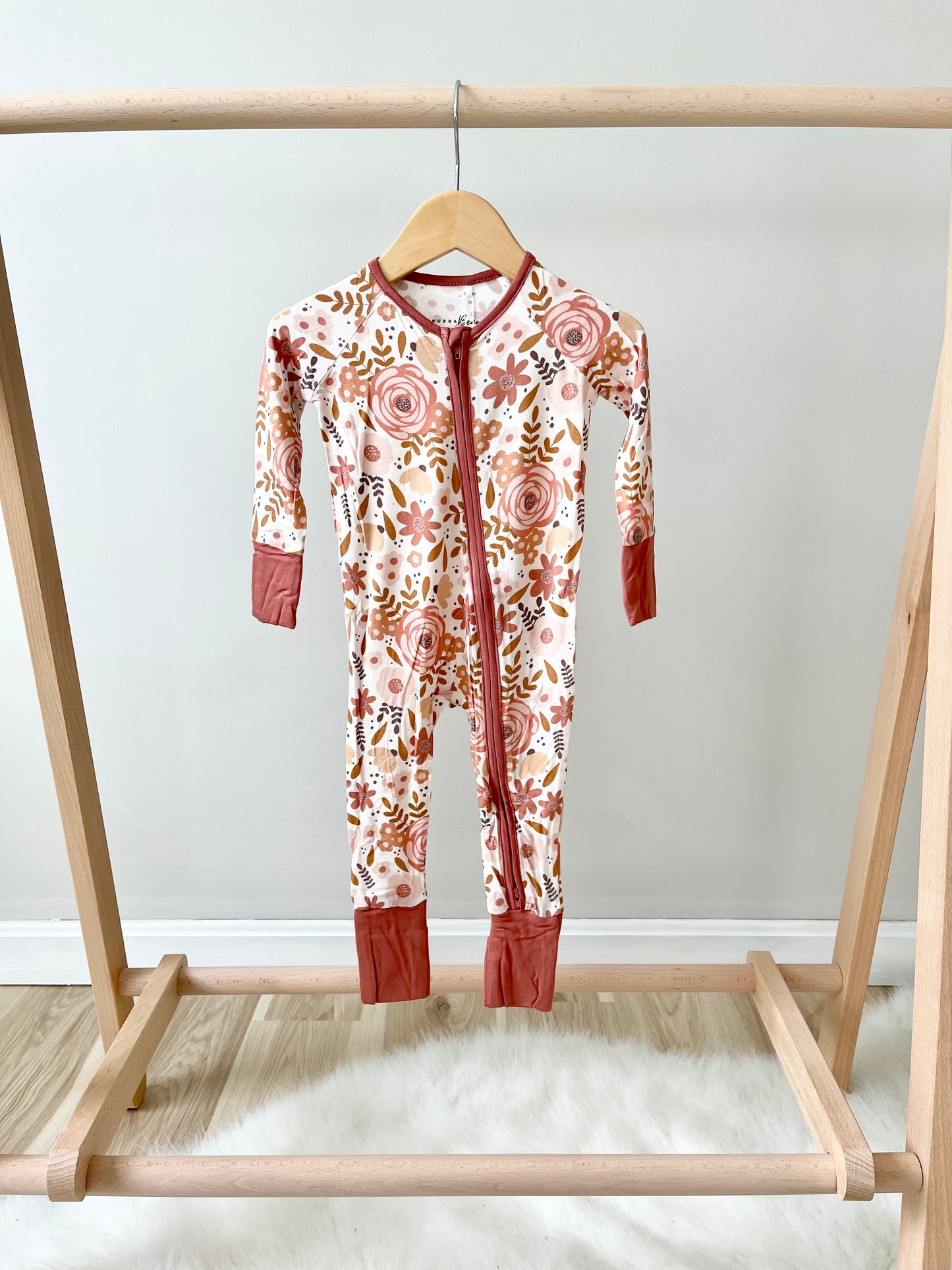 mauve floral bamboo onesie hanging